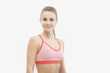 Obraz premium Sports blonde girl in red training clothes in the studio on a white background.