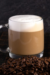 Cafe Latte Coffee in a Clear Glass Mug in a Dark Environment