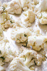 Trays with raw cauliflower ready to be roasted