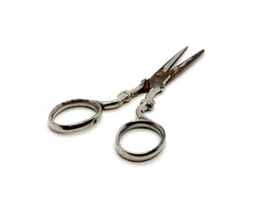 Old retro scissors with scratches and rust isolated on white background.