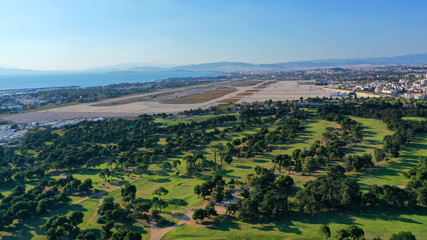 Obraz premium Aerial drone photo of famous Golf course in Glyfada area next to abandoned Elliniko airport, South Athens riviera, Attica, Greece