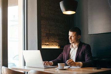 Young handsome businessman conducting negotiations with investors. Electronic business. Alternative...