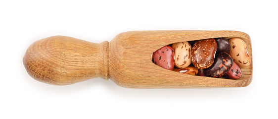 variegated kidney bean in wooden spoon isolated on white background. Top view. Flat lay