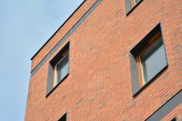 Fototapeta na wymiar Fragment of a modern apartment building in front. Very modern apartment house.