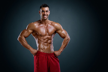 Fototapeta na wymiar Handsome Body Builder Flexing Muscles