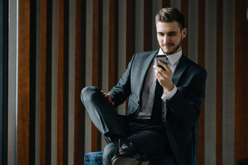 Young handsome businessman conducting negotiations with investors. Electronic business. Alternative...
