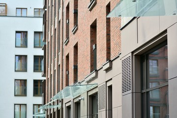 Naklejka premium Fragment of a modern apartment building in front. Very modern apartment house.