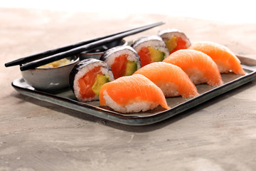 close up of sashimi sushi set with chopsticks and soy - sushi roll with salmon and sushi roll with smoked eel