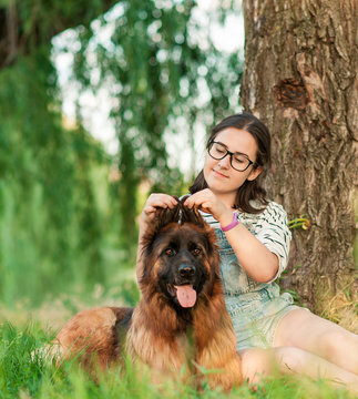 Portrait of young beautiful woman sitting and hugging her German Shepherd dog. Happiness and friendship. pet and woman.