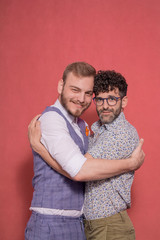 two men, gay couple looking to camera.