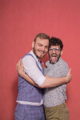 gay men acting silly, hugging together.