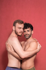 Fototapeta na wymiar two men, gay couple, shirtless posing in a studio, photo-shoot