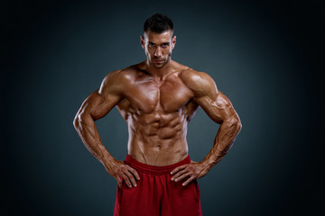 Fototapeta na wymiar Handsome Body Builder Flexing Muscles