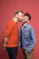 gay couple together, kiss on a cheek.