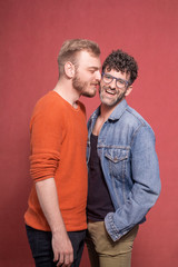 gay couple, intimate cuddling in front of camera.