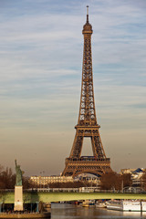 Fototapeta na wymiar Paris, France - February 16, 2019: Liberty statue and Eiffel Tower near river seine in Paris