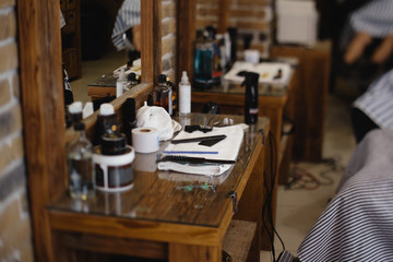 Vintage barber or shaver tools on wooden table in a barbershop