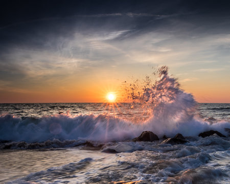 Crashing waves and colorful sky at sunrise in Ocean City, MD. Photo by: Chuck Beyer