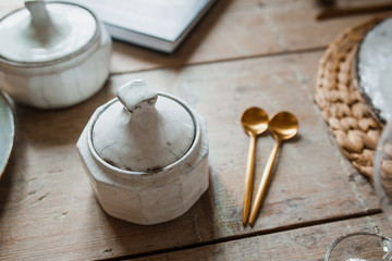 White plate and golden fork with a spoon, appliances for frying, wedding decoration. Christmas or tanksgiving dinner. From above