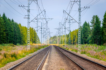 Obraz na płótnie Canvas Summer Russian Railway. Rails and sleepers. Railroad among the scape.