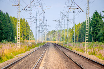 Fototapeta na wymiar Summer Russian Railway. Rails and sleepers. Railroad among the scape.
