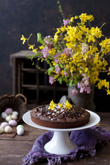 Easter orthodox sweet chocolate bread and colorful quail eggs on white background. Easter holidays breakfast concept with copy space
