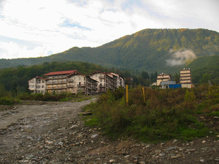 Gravel road to mountain hotels in Krasnaya Polyana at sunny day