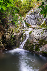 Fototapeta na wymiar Small waterfall in the summer