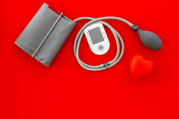 diagnostics of cardiac disease with pulsimeter on red background top view copyspace
