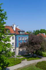 Fototapeta na wymiar Early color houses surrounded by green trees. Warsaw