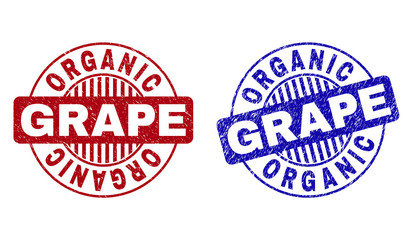 Grunge ORGANIC GRAPE round watermarks isolated on a white background. Round seals with grunge texture in red and blue colors.