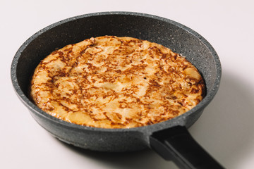 tortilla de patatas on white background, typical spanish dish