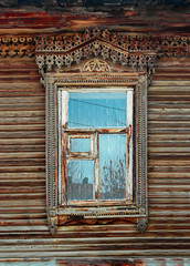 Obsolete ornate carved wooden window in old russian style