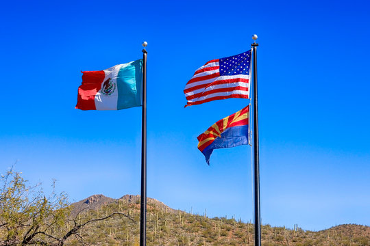 Mexican, American and Arizona state Flags at the Border between the two countries