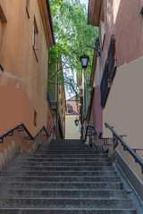 Narrow street with stairs up and vintage lanterns. Warsaw.