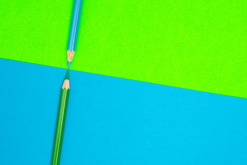 Color Pencils on Blue and Green Background. Coloring pencils for drawing. Colored Art Pencils. School and Office Supplies. Student Stationery. Abstract background. Colorful and creative.