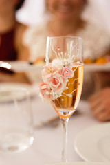 Champagne glass closeup with depth of field blur - Wedding Setup decoration during Reception - Tender pink and white color - Zephyr and marshmallow details