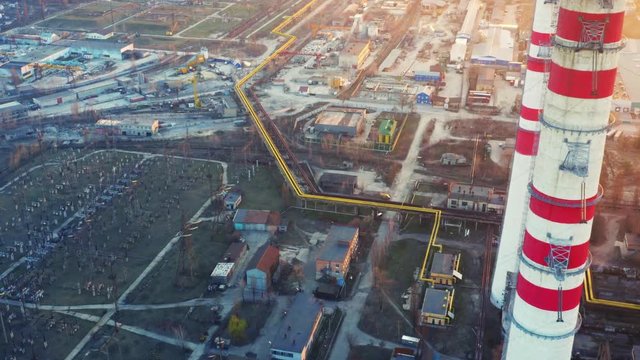 Aerial view of  CHP plant (coal-fired power station) with smoking chimneys at sunset