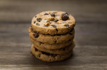 Classic chocolate chip cookies against wooden background. Concept of dessert, baking, and sweet food
