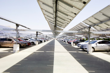 Many cars are parked under the solar photovoltaic panel