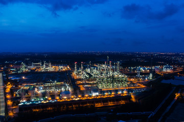 Obraz premium Aerial view or top view night light oil terminal is industrial facility for storage of oil and petrochemical. oil manufacturing products ready for transport and business transportation. power electric