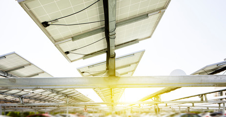 Many solar photovoltaic panels are installed on the top of the open-air parking lot.
