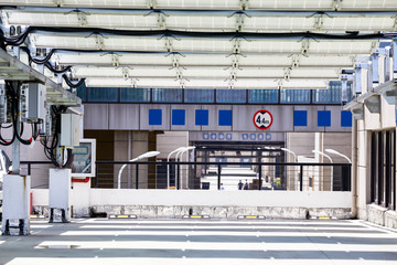 Many solar photovoltaic panels are installed on the top of the open-air parking lot.