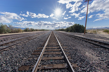 Fototapeta na wymiar Railroad tracks headed west in the Mojave desert at Kelso junction.