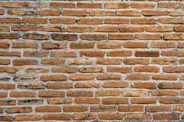 Old dirty vintage orange brick wall with cement detail texture material backgrounds. Ancient wall grunge brickwork background for mockup or interior design concept