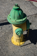 Yellow and green vintage fire hydrant. 