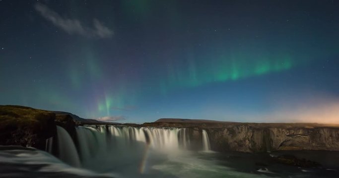 Timelapse of amazing northern lights over waterfall in Iceland