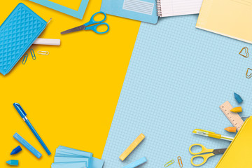Yellow and blue stationery items around of image. Back to school background, banner with copy...