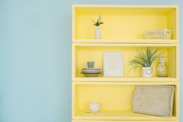 Cabinet for dishes. Bright colors in the kitchen. Blue and yellow.