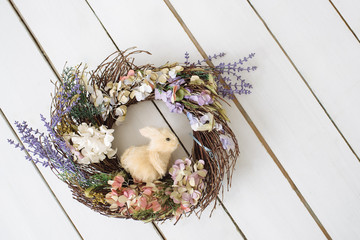 Easter wreath with rabbit. Wooden floor. Background. Easter.